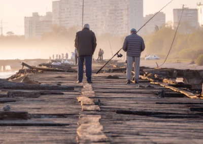 Eldery men seen from behind fishing